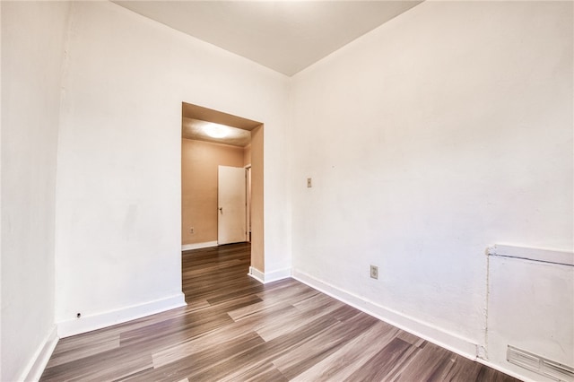 unfurnished room with wood-type flooring