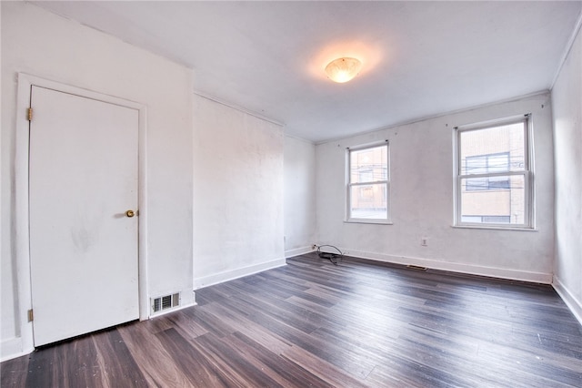 unfurnished room featuring dark hardwood / wood-style flooring