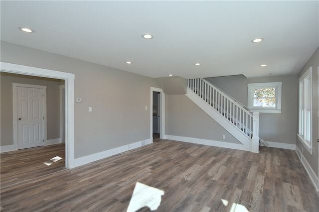 unfurnished living room with dark hardwood / wood-style floors