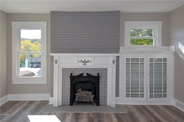 interior details featuring hardwood / wood-style flooring and a fireplace