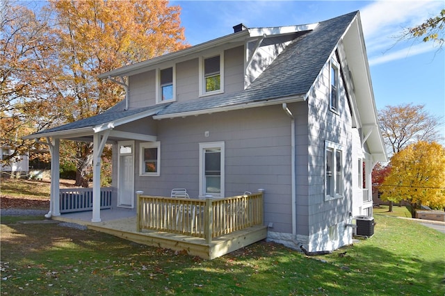 rear view of property with a yard