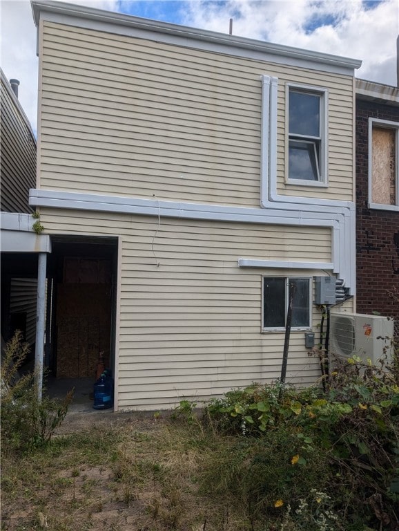 view of side of home with ac unit