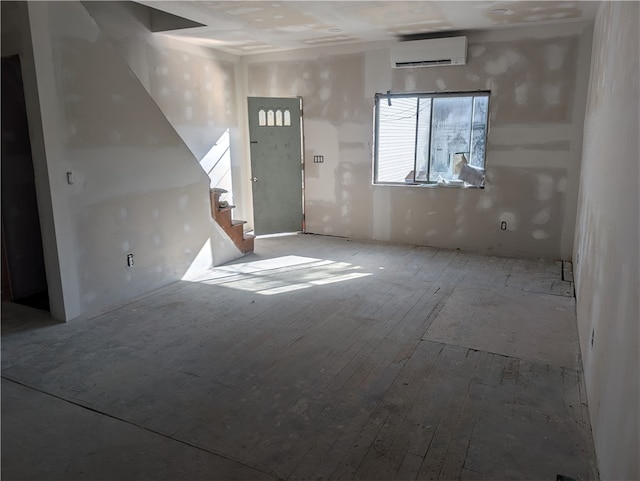 interior space with an AC wall unit and wood-type flooring