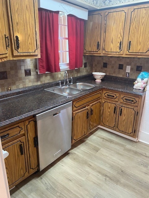 kitchen with sink, decorative backsplash, light hardwood / wood-style flooring, and stainless steel dishwasher