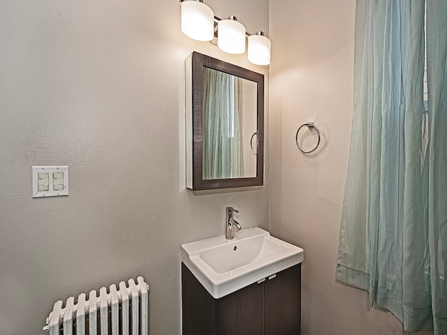 bathroom featuring vanity and radiator heating unit