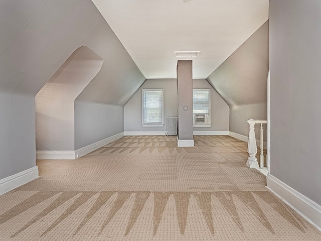 bonus room featuring lofted ceiling and light colored carpet