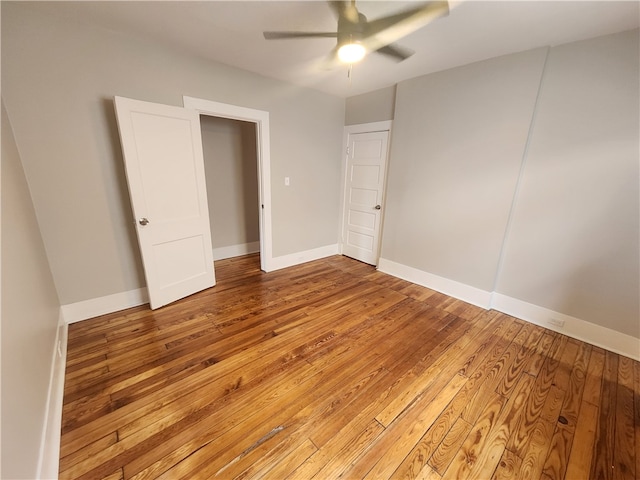 empty room featuring ceiling fan and hardwood / wood-style floors