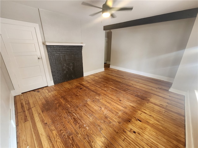 unfurnished living room featuring wood-type flooring, a fireplace, and ceiling fan