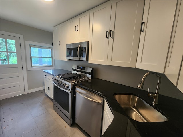 kitchen featuring sink, white cabinets, and stainless steel appliances