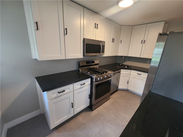 kitchen featuring stainless steel appliances, sink, and white cabinets