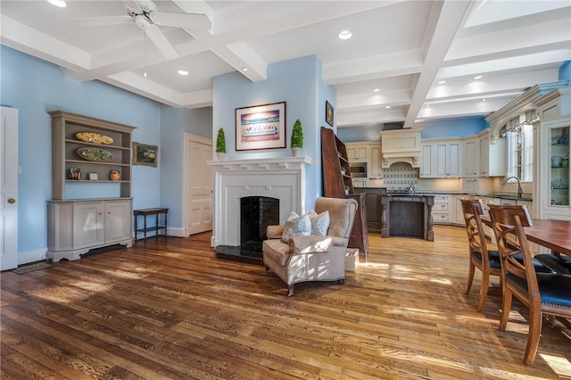 living room featuring a fireplace, hardwood / wood-style floors, and beamed ceiling