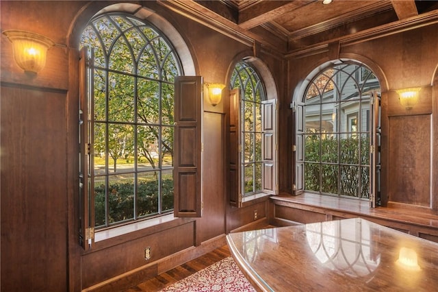 doorway with beamed ceiling, hardwood / wood-style floors, crown molding, and coffered ceiling