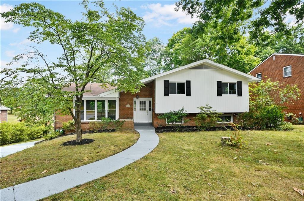 1219 Holy Cross Dr, Monroeville, PA 15146 - tri-level home with brick siding and a front yard
