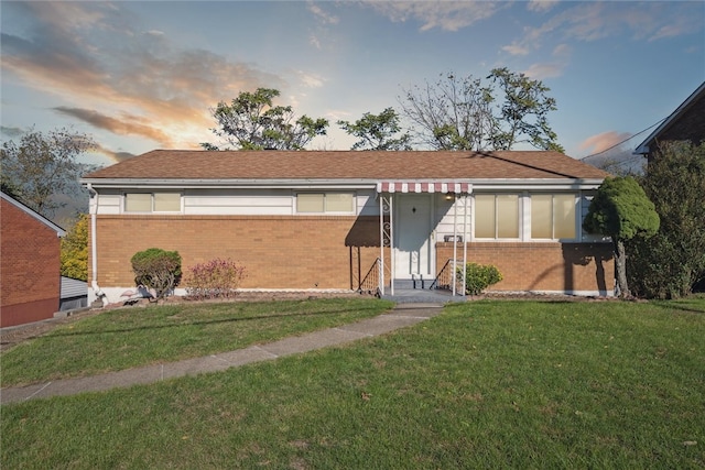 ranch-style house with a yard