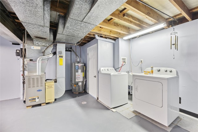 basement featuring heating unit, separate washer and dryer, and gas water heater