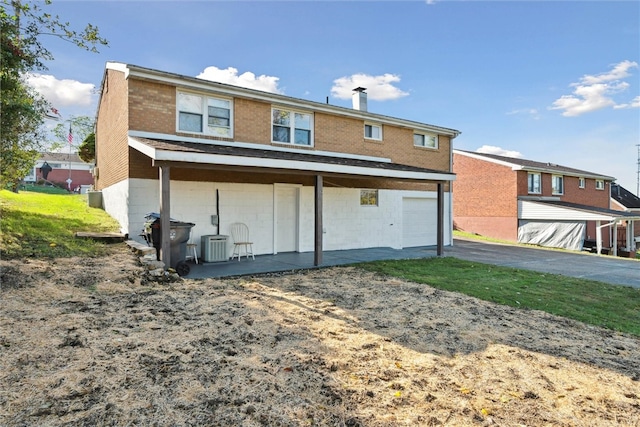 rear view of house with a garage