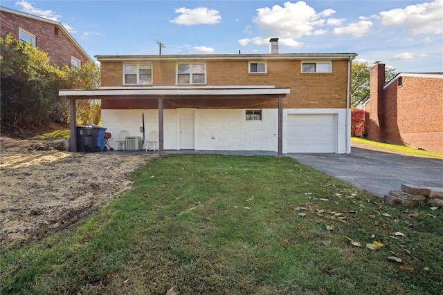 back of property featuring central AC, a garage, and a lawn