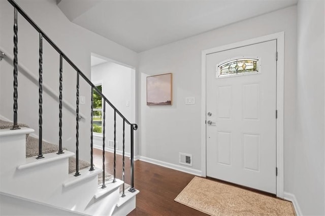 foyer with dark hardwood / wood-style floors