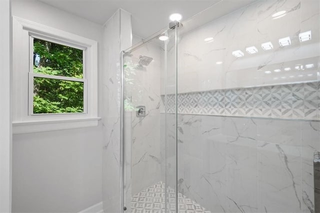 bathroom featuring a shower with shower door