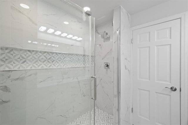 bathroom with a shower with door