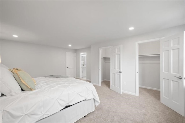 carpeted bedroom with a closet and a spacious closet