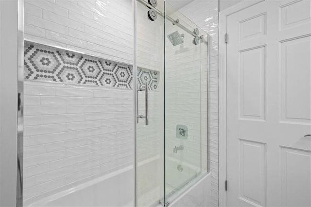 bathroom featuring bath / shower combo with glass door