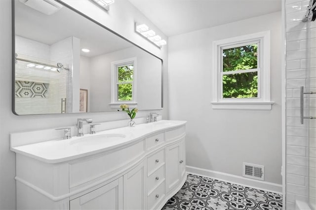 bathroom with vanity, tile patterned flooring, and walk in shower