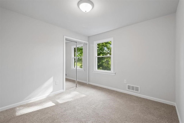 empty room featuring light colored carpet