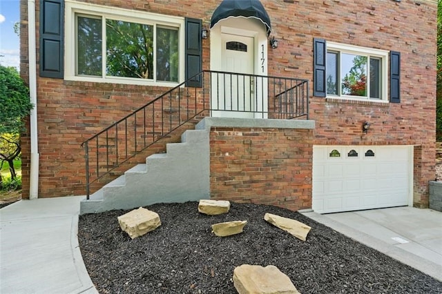 doorway to property with a garage