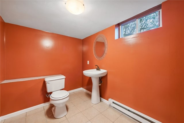 bathroom featuring baseboard heating, tile patterned floors, sink, and toilet