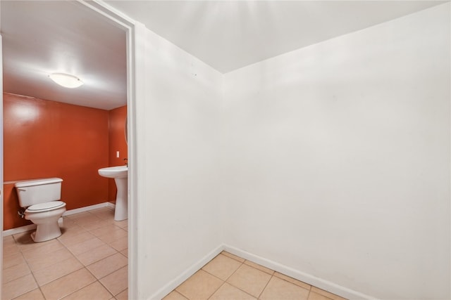 bathroom with toilet and tile patterned floors