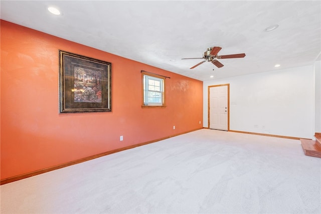 unfurnished room featuring light colored carpet and ceiling fan