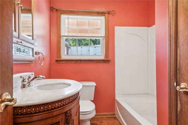 bathroom featuring vanity, toilet, and hardwood / wood-style floors