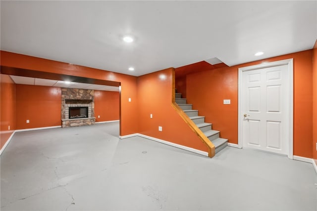 unfurnished living room featuring concrete floors and a fireplace