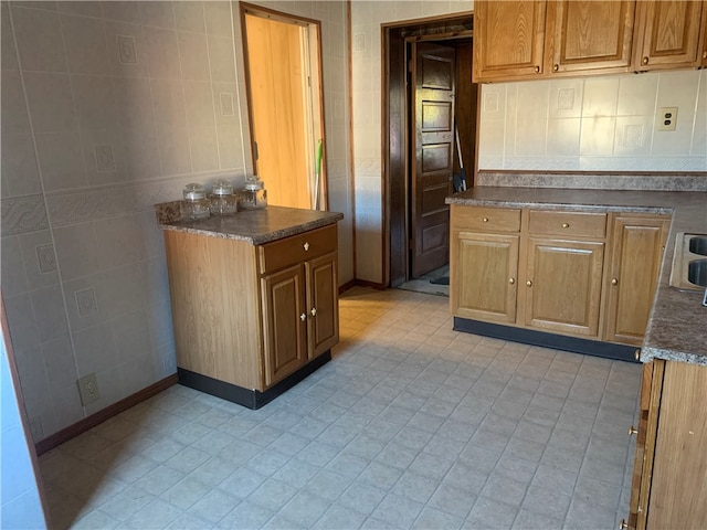 kitchen featuring tile walls