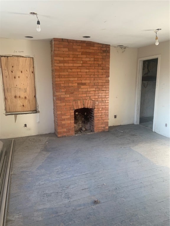 unfurnished living room featuring a brick fireplace