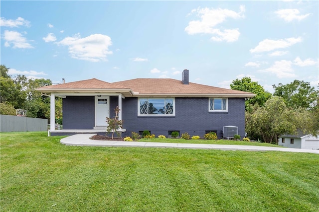 view of front of property with a front yard and central AC