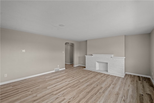 unfurnished living room with light wood-type flooring