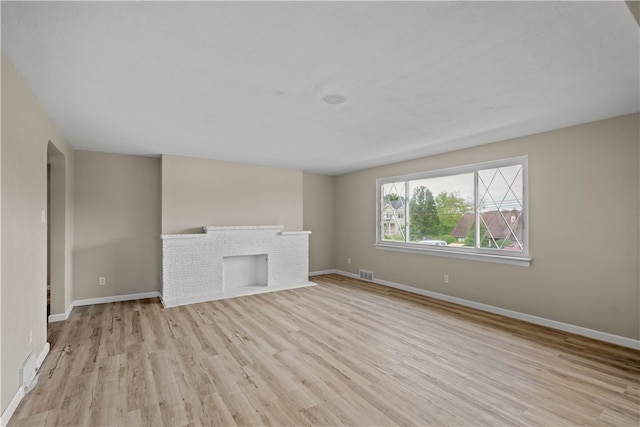 unfurnished living room with light hardwood / wood-style flooring