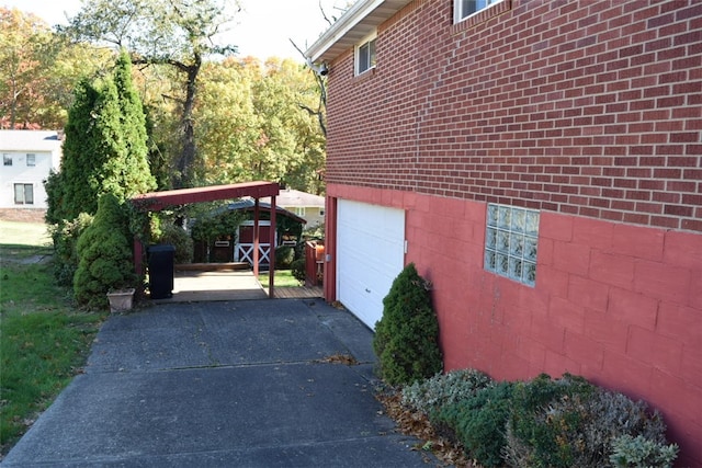 view of side of home with a garage and a carport