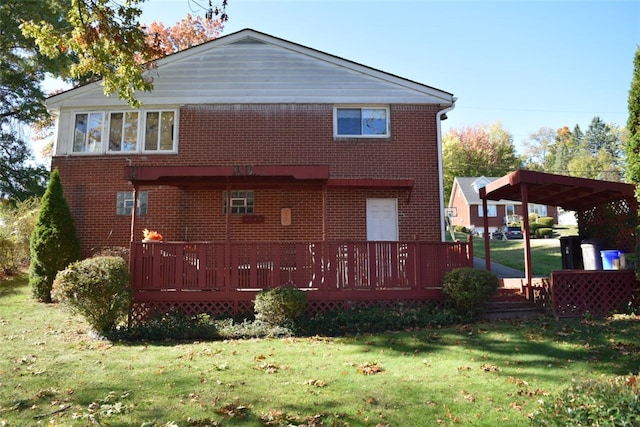 rear view of house featuring a yard and a wooden deck