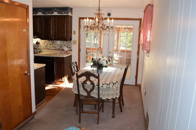 dining space with an inviting chandelier