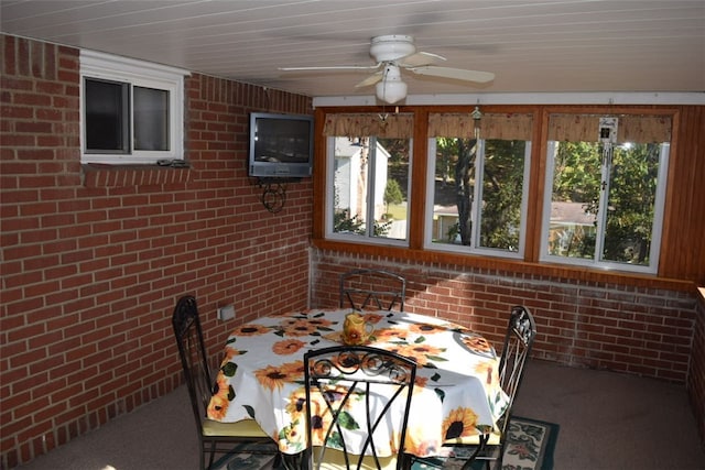 unfurnished sunroom with ceiling fan