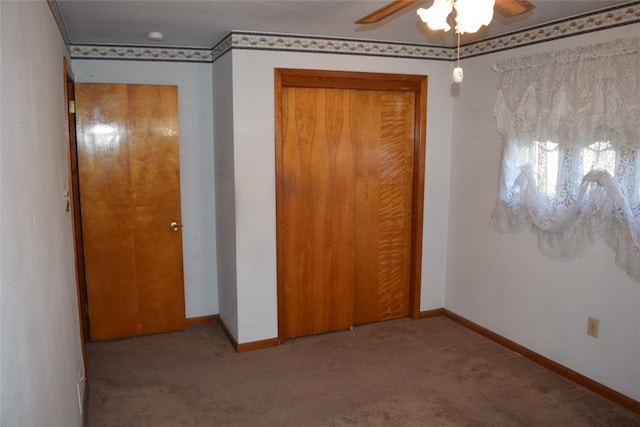 unfurnished bedroom with ceiling fan, crown molding, and light colored carpet