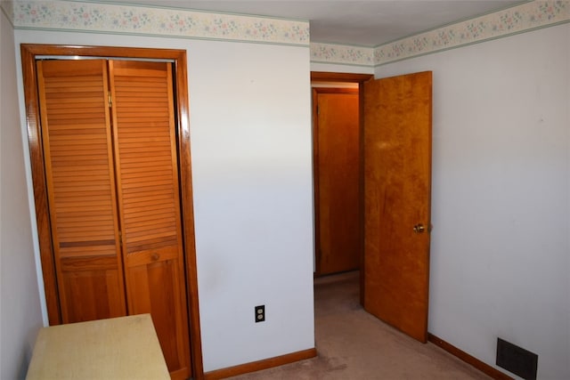 carpeted bedroom with a closet