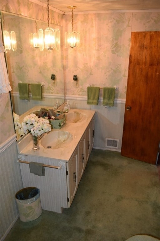 bathroom with vanity and a notable chandelier