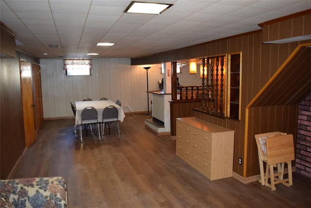 dining area with hardwood / wood-style floors and wooden walls