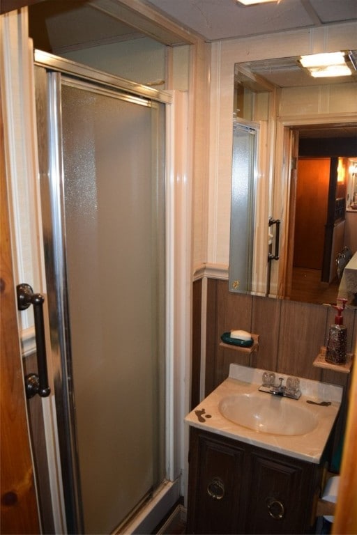 bathroom with vanity and a shower with shower door