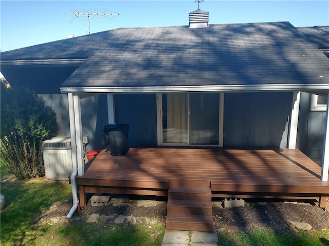 rear view of house featuring a deck and cooling unit