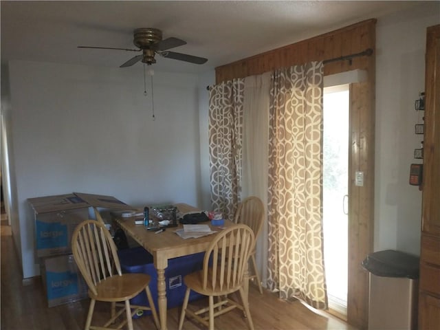dining room with wood finished floors and a ceiling fan